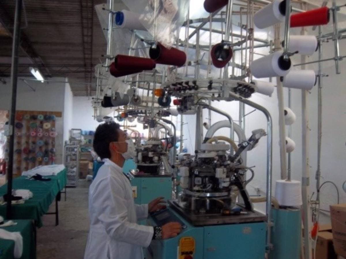 Factory operator running production machinery